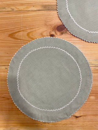 2 large round light grey table mats with silver scallop border at the rim and interior circle. Shop designer tableware in Bangalore