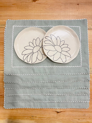 6 light grey rectangle table mats with silver scallop lace border and inner rectangle border, 2 plates on top mat. Explore kitchenware in Bangalore