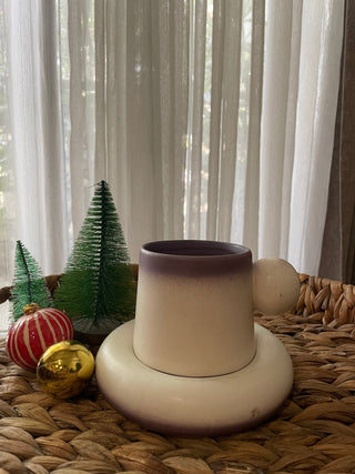 Pinteresty cup saucer: short ceramic mug with big ball handle, bulky saucer, off-white with purple glaze, on wicker tray with xmas decor. Shop designer tableware Bangalore