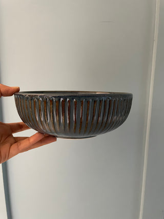 Hand holding aqua blue ceramic bowl with ribbed vintage design. Shop designer tableware in Bangalore at Oh Yay Project.