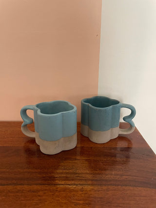 2 flower shape ceramic mug, 4-petal design with curved rim double-curve handle, stoneware finish in half blue and half beige. Explore home decor gifts in India