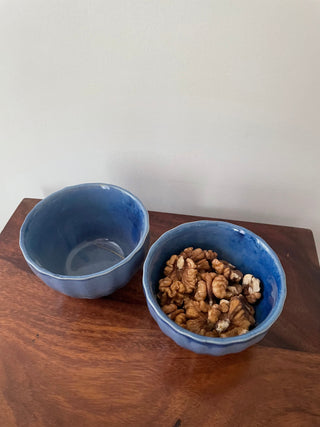 2 blue glazed small bowls. One filled with walnuts, one empty. Top shot showing design. Shop tableware for special occasions in India